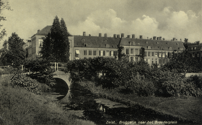 15974 Gezicht op de toegangsbrug naar het Broederplein met plantsoen te Zeist uit het zuidwesten; met op de achtergrond ...